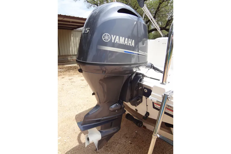 Slide: The Image of 2022 Hurricane SunDeck Sport 185 OB with Yamaha outboard motor, parked outdoors. - 32