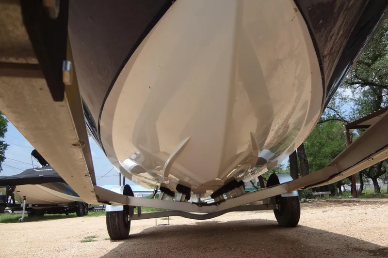 Slide: The Image of 2022 Hurricane SunDeck Sport 185 OB boat underside on trailer, showcasing hull design. - 35