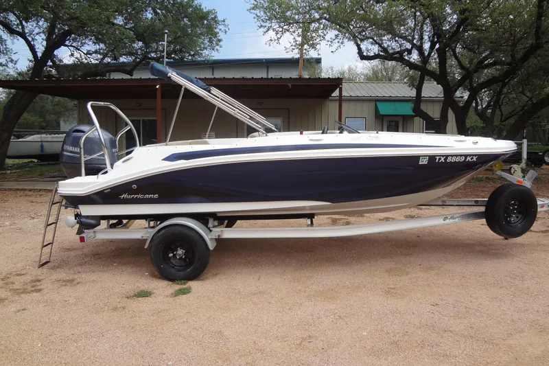 Slide: The Image of 2022 Hurricane SunDeck Sport 185 OB boat on trailer, parked outdoors. - 5