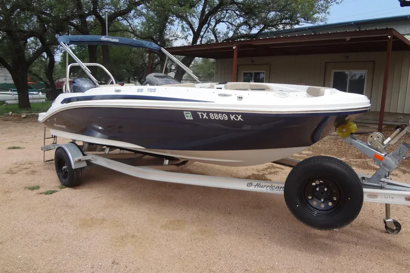 Slide: The Image of 2022 Hurricane SunDeck Sport 185 OB boat on trailer, parked outdoors. - 6