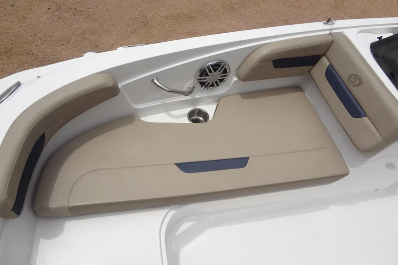 Slide: The Image of 2022 Hurricane SunDeck Sport 185 OB boat interior seating with beige cushions and speaker. - 9