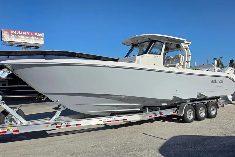 The Image of 2026 Solace 35CS boat on trailer under clear blue sky. - 1