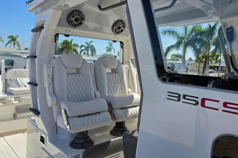 Slide: The Image of Luxury seating on 2026 Solace 35CS boat with palm trees in background. - 10