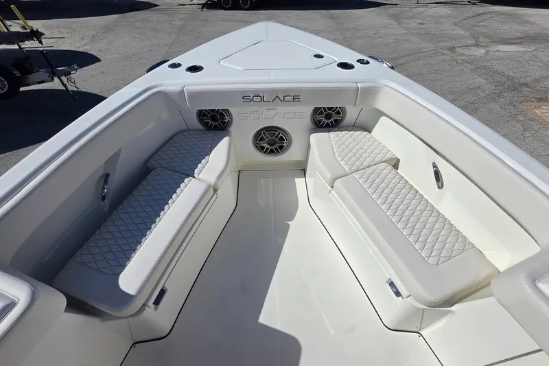 Slide: The Image of Luxurious seating area on the 2026 Solace 35CS boat, featuring quilted cushions and speakers. - 17