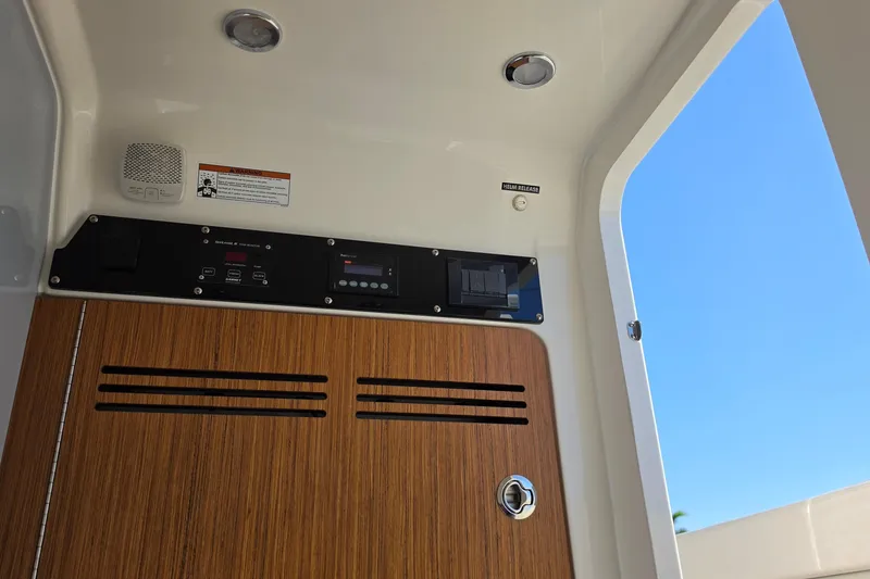Slide: The Image of Interior view of 2026 Solace 35CS boat, featuring control panel and wooden cabinet. - 19