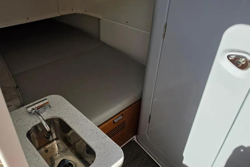 Slide: The Image of 2026 Solace 35CS cabin interior with sink and cushioned bed. - 21
