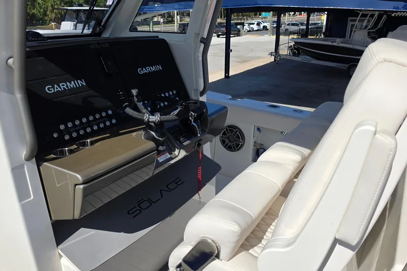 Slide: The Image of Interior of 2026 Solace 35CS boat with Garmin navigation displays and white seating. - 25
