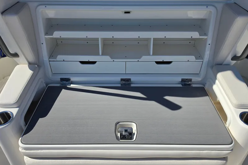 Slide: The Image of Storage compartment on a 2026 Solace 35CS boat, featuring shelves and drawers. - 26