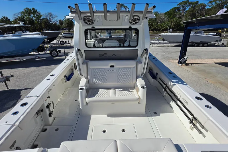 Slide: The Image of 2026 Solace 35CS boat interior with seating and rod holders, docked outdoors. - 28
