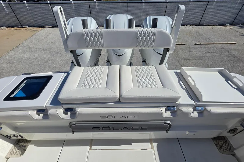 Slide: The Image of 2026 Solace 35CS boat with cushioned seating and storage compartments. - 29