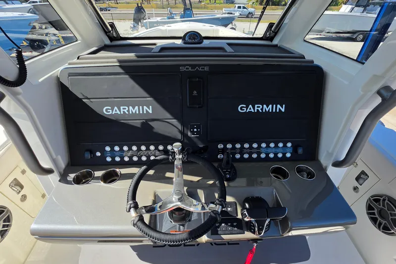 Slide: The Image of Helm of 2026 Solace 35CS boat featuring dual Garmin displays and modern controls. - 30