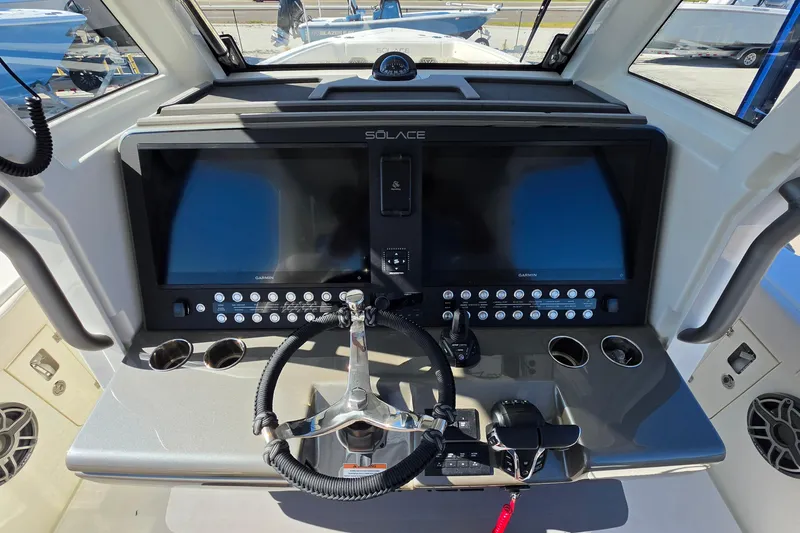 Slide: The Image of 2026 Solace 35CS boat dashboard with dual screens and steering wheel. - 31