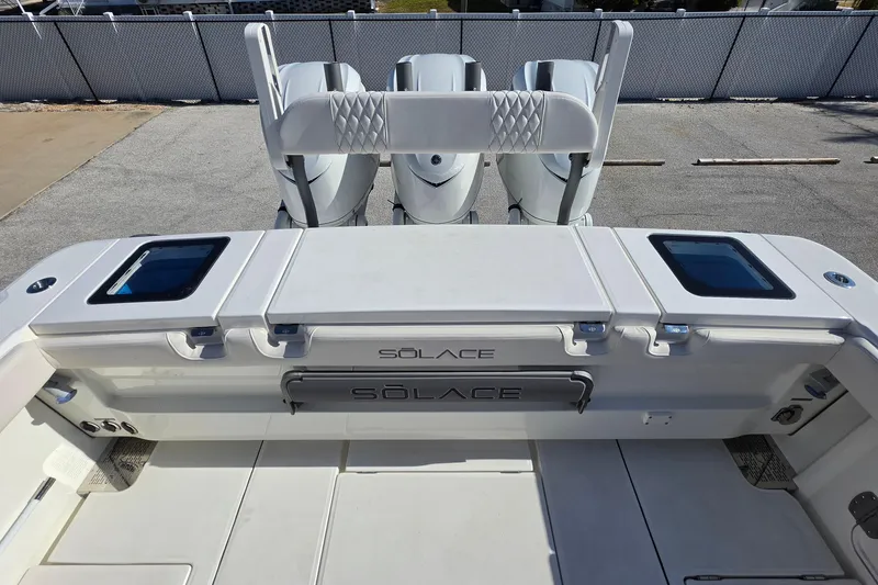 Slide: The Image of 2026 Solace 35CS boat deck with triple engines and storage compartments. - 33