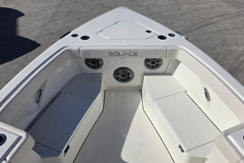 Slide: The Image of Bow seating area of 2026 Solace 35CS boat with integrated speakers and cup holders. - 34