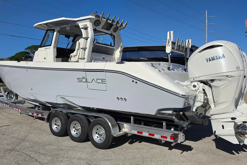 Slide: The Image of 2026 Solace 35CS boat on trailer with Yamaha engine, parked outdoors. - 4