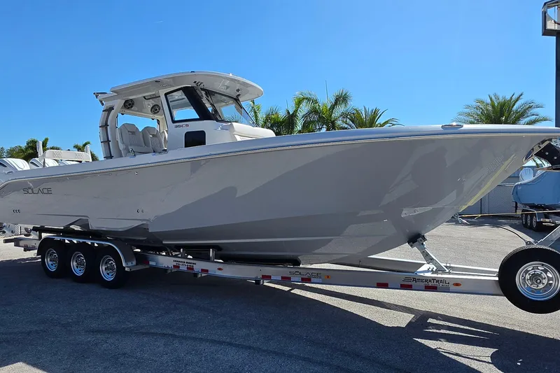 Slide: The Image of 2026 Solace 35CS boat on trailer, parked outdoors under clear blue sky. - 7