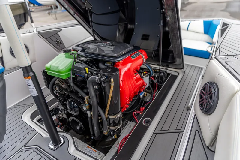 Slide: The Image of 2021 Nautique Ski Nautique boat engine compartment with open hatch, showcasing detailed components. - 3