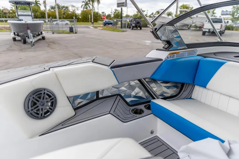 Slide: The Image of 2021 Nautique Ski Nautique boat interior with blue and white seating, geometric accents. - 9