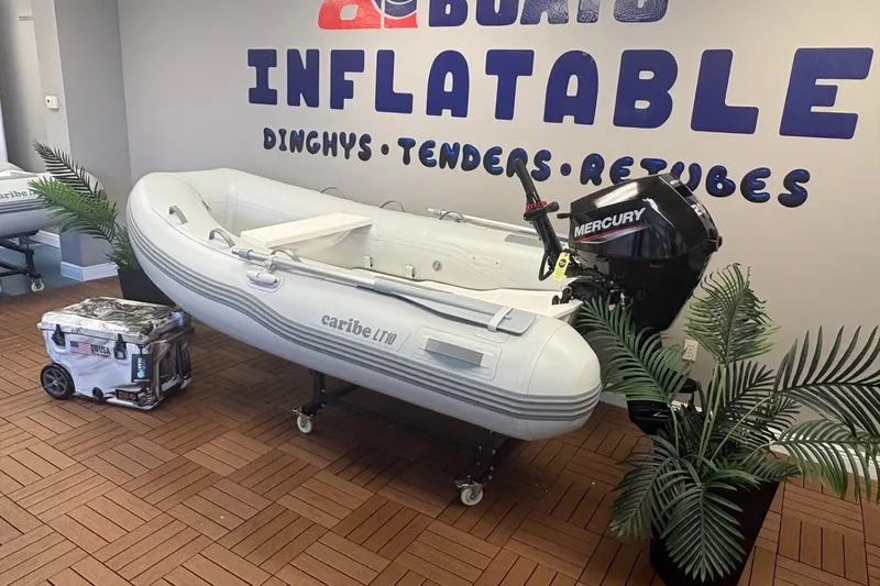 Slide: The Image of Inflatable Caribe L-10 boat with Mercury motor in showroom, 2025 model. - 2
