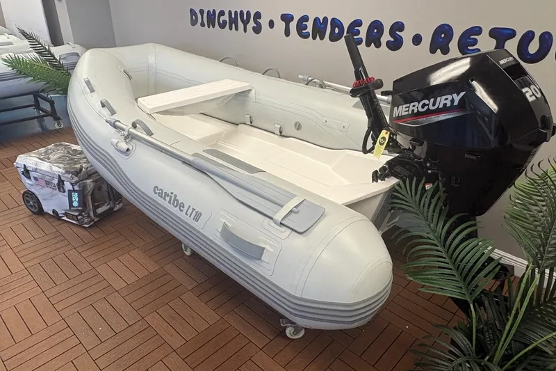 Slide: The Image of Inflatable Caribe L-10 boat with Mercury engine, displayed indoors, 2025 model. - 3