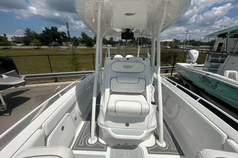 Slide: The Image of 2022 Glasstream 280 Pro-XS boat interior with seating and console, under a sunny sky. - 11