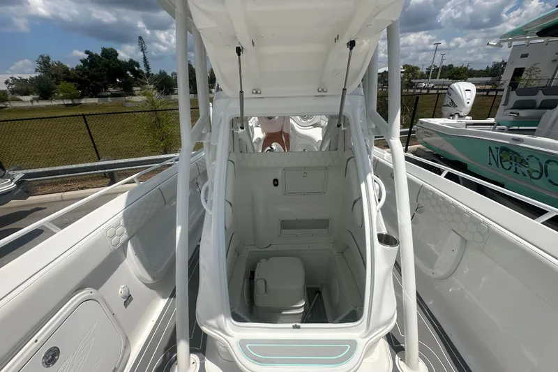 Slide: The Image of 2022 Glasstream 280 Pro-XS boat interior with open hatch and visible toilet. - 14