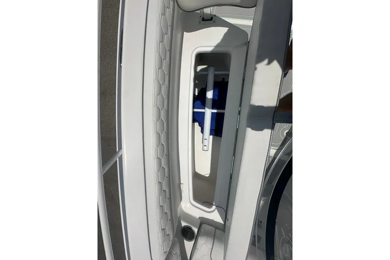 Slide: The Image of 2022 Glasstream 280 Pro-XS boat interior storage compartment with white cushioned seating. - 18