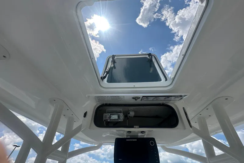 Slide: The Image of View from inside a 2022 Glasstream 280 Pro-XS boat, looking up at the sky through a hatch. - 21