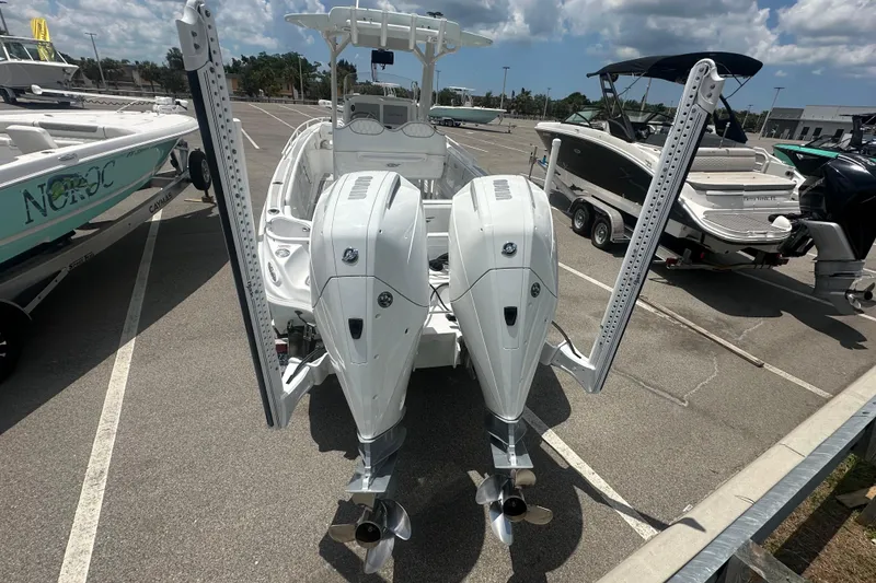 Slide: The Image of 2022 Glasstream 280 Pro-XS boat with dual outboard motors in a marina. - 3