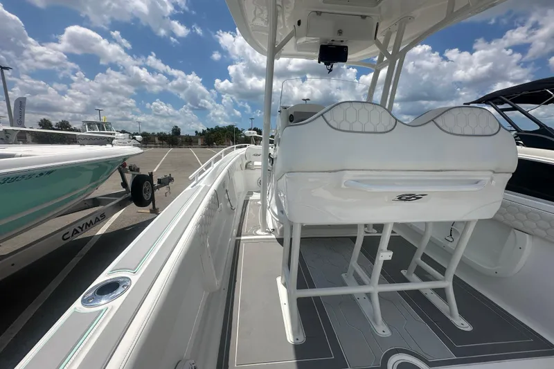 Slide: The Image of 2022 Glasstream 280 Pro-XS boat interior with seating, parked under a cloudy sky. - 7