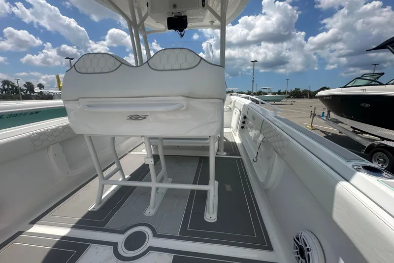 Slide: The Image of 2022 Glasstream 280 Pro-XS boat interior with seating and deck, under a partly cloudy sky. - 8
