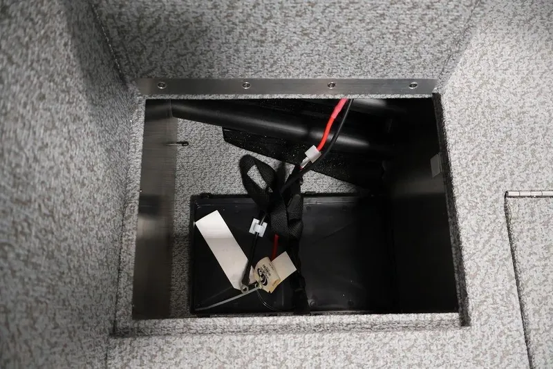 Slide: The Image of Storage compartment in 2027 Crestliner 1650 Kodiak WT boat, featuring wiring and secure fittings. - 22