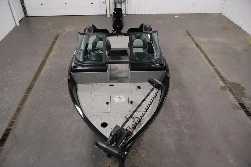 Slide: The Image of 2027 Crestliner 1650 Kodiak WT boat in a garage, showcasing interior and windshield. - 35