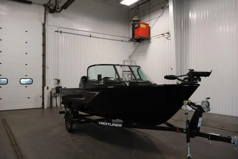 Slide: The Image of 2027 Crestliner 1650 Kodiak WT boat in a spacious indoor garage setting. - 64