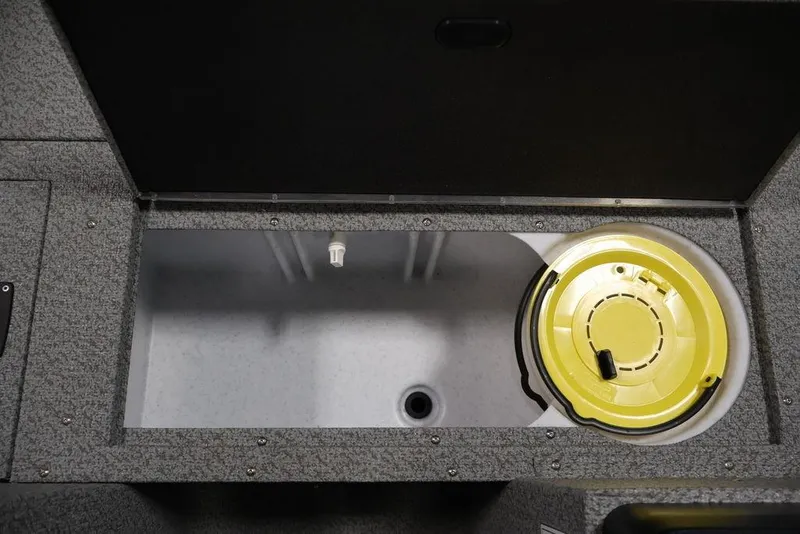 Slide: The Image of 2027 Crestliner 1650 Kodiak WT boat storage compartment with yellow lid. - 28