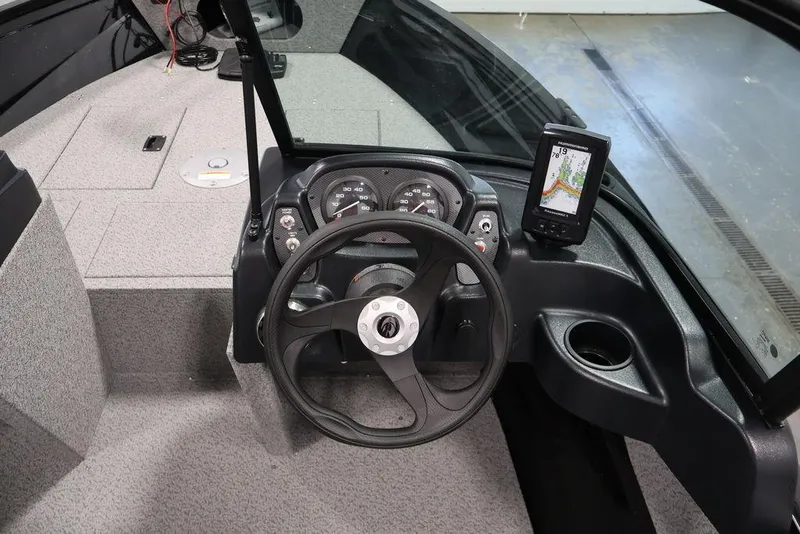 Slide: The Image of 2027 Crestliner 1650 Kodiak WT boat dashboard with steering wheel and navigation system. - 23