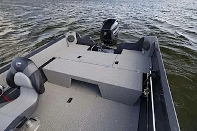 Slide: The Image of 2027 Crestliner 1650 Kodiak WT boat interior with motor on a lake. - 65