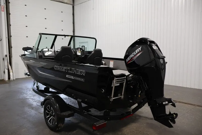 Slide: The Image of 2027 Crestliner 1650 Kodiak WT boat with Mercury engine in a garage setting. - 30
