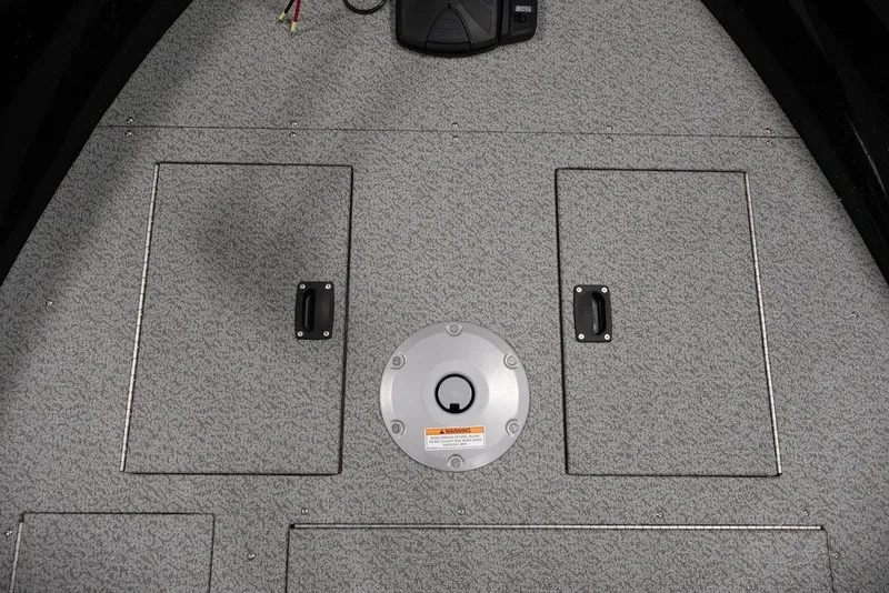Slide: The Image of 2027 Crestliner 1650 Kodiak WT boat deck with storage compartments and circular hatch. - 29
