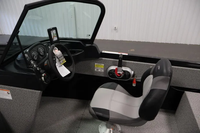 Slide: The Image of 2027 Crestliner 1650 Kodiak WT boat interior with steering wheel and control panel. - 24