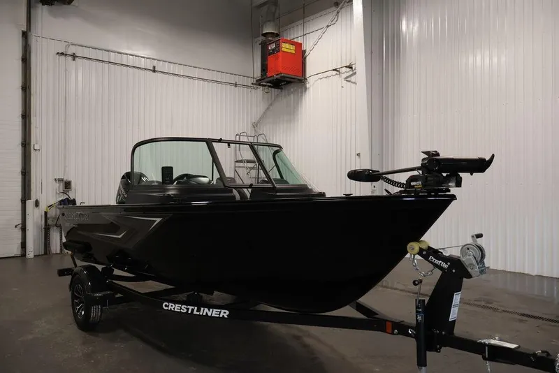 Slide: The Image of 2027 Crestliner 1650 Kodiak WT boat in a garage, showcasing sleek design and modern features. - 15