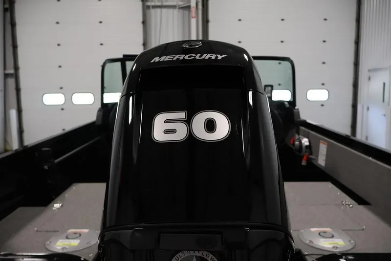 Slide: The Image of 2027 Crestliner 1650 Kodiak WT with Mercury 60 horsepower engine in a garage. - 56
