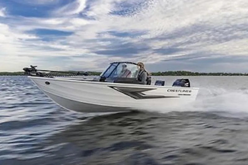 Slide: The Image of 2027 Crestliner 1650 Kodiak WT boat speeding on a lake under a cloudy sky. - 63