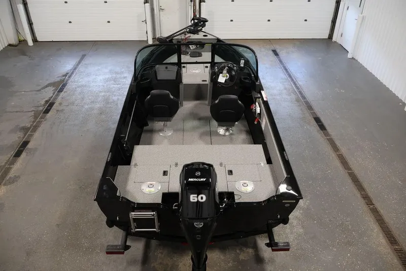 Slide: The Image of 2027 Crestliner 1650 Kodiak WT boat in garage, featuring Mercury 60 engine. - 32