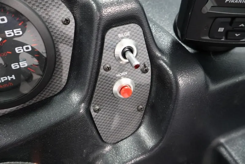 Slide: The Image of Dashboard controls of 2027 Crestliner 1650 Kodiak WT boat, featuring speedometer and switches. - 33