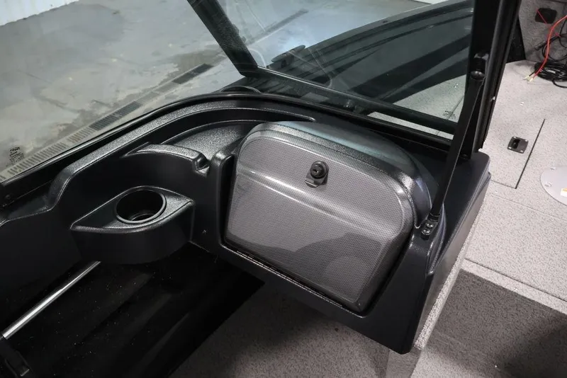 Slide: The Image of Interior view of 2027 Crestliner 1650 Kodiak WT boat, featuring a storage compartment and cup holder. - 48