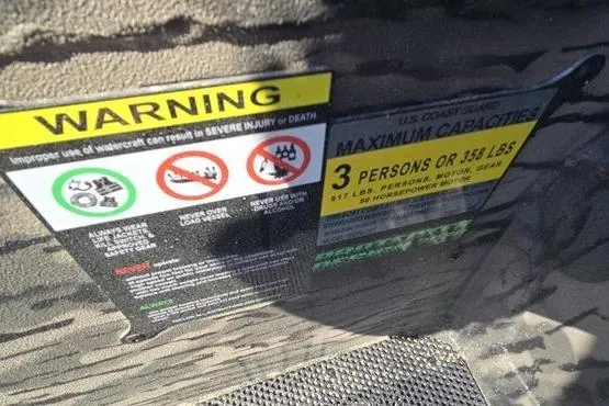 Slide: The Image of Warning labels on a 2026 Havoc 1553 VJST boat, indicating maximum capacity and safety instructions. - 10
