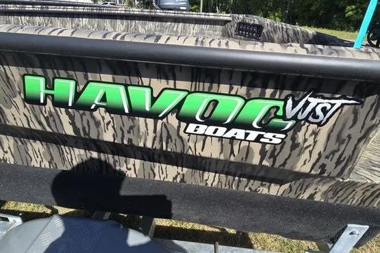 Slide: The Image of Camouflage-patterned Havoc 1553 VJST boat with bold green logo, 2026 model. - 5