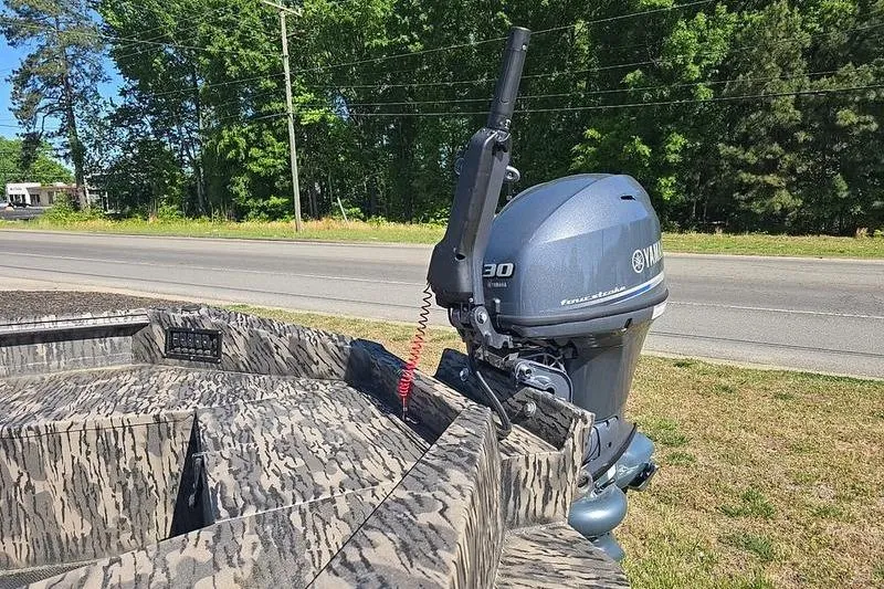 Slide: The Image of Camouflage-patterned 2026 Havoc 1760 VJST boat with Yamaha outboard motor, parked roadside. - 8