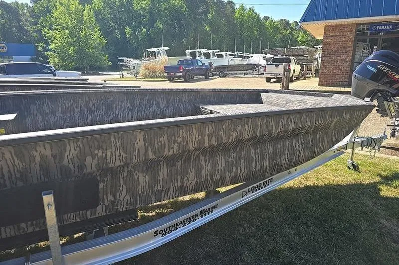 Slide: The Image of 2026 Havoc 1760 VJST boat with camouflage design on a trailer at a dealership. - 9